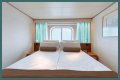 An old Holland America cruise ship is turning residential, letting travelers live at sea for $8,000 a month while it circumnavigates the globe